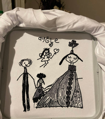 Kids drawing custom embroidery on a T-shirt