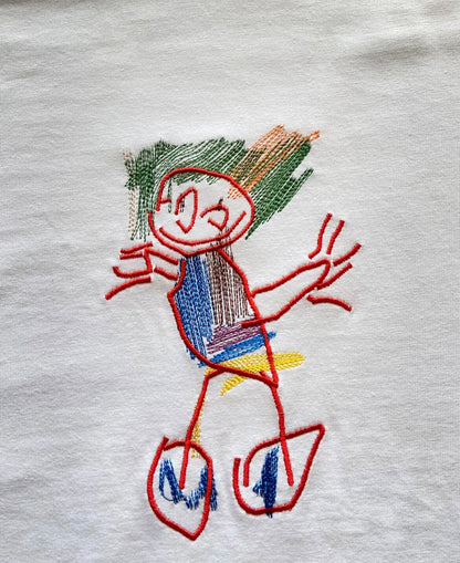 Kids drawing custom embroidery on a T-shirt