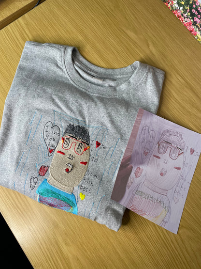 Kids drawing custom embroidery on a T-shirt