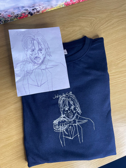 Kids drawing custom embroidery on a T-shirt